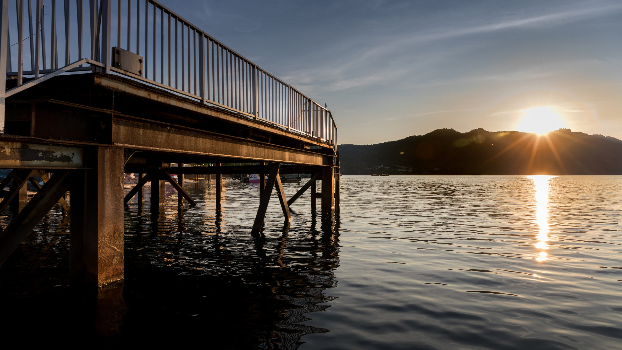 Dock At Lake And Mountain At Sunset Or Sunrise